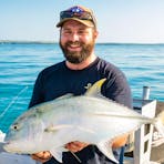 Giant trevally caught on Darwin Harbour, displaying its powerful build and silvery-grey scales.