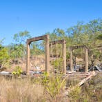 Remains of a building destroyed by fire. Refuse contains asbestos cladding.