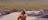 Woman sitting in water at top of Gunlom Falls, Kakadu