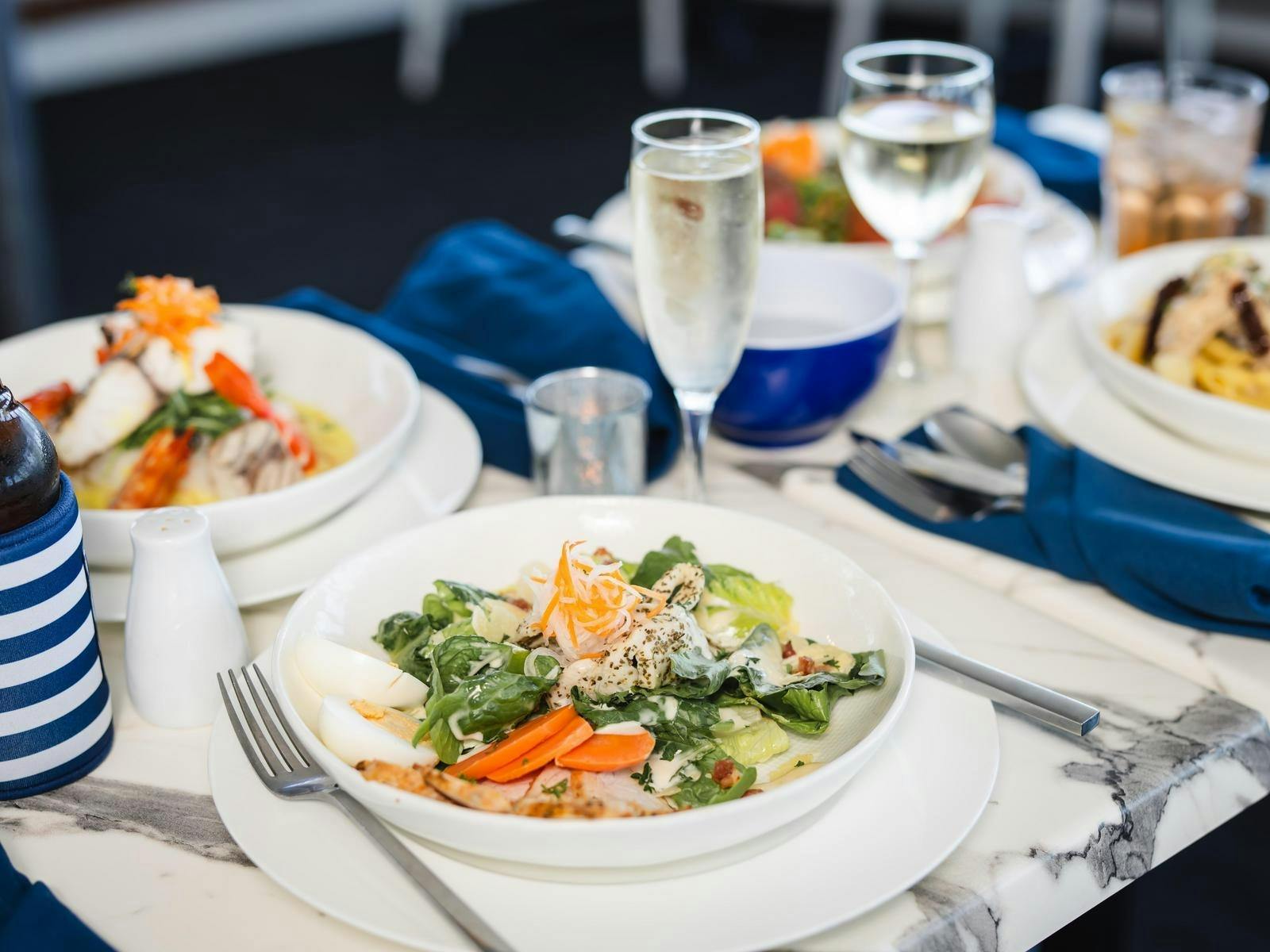 Multiple plates of  food from on board buffet choices