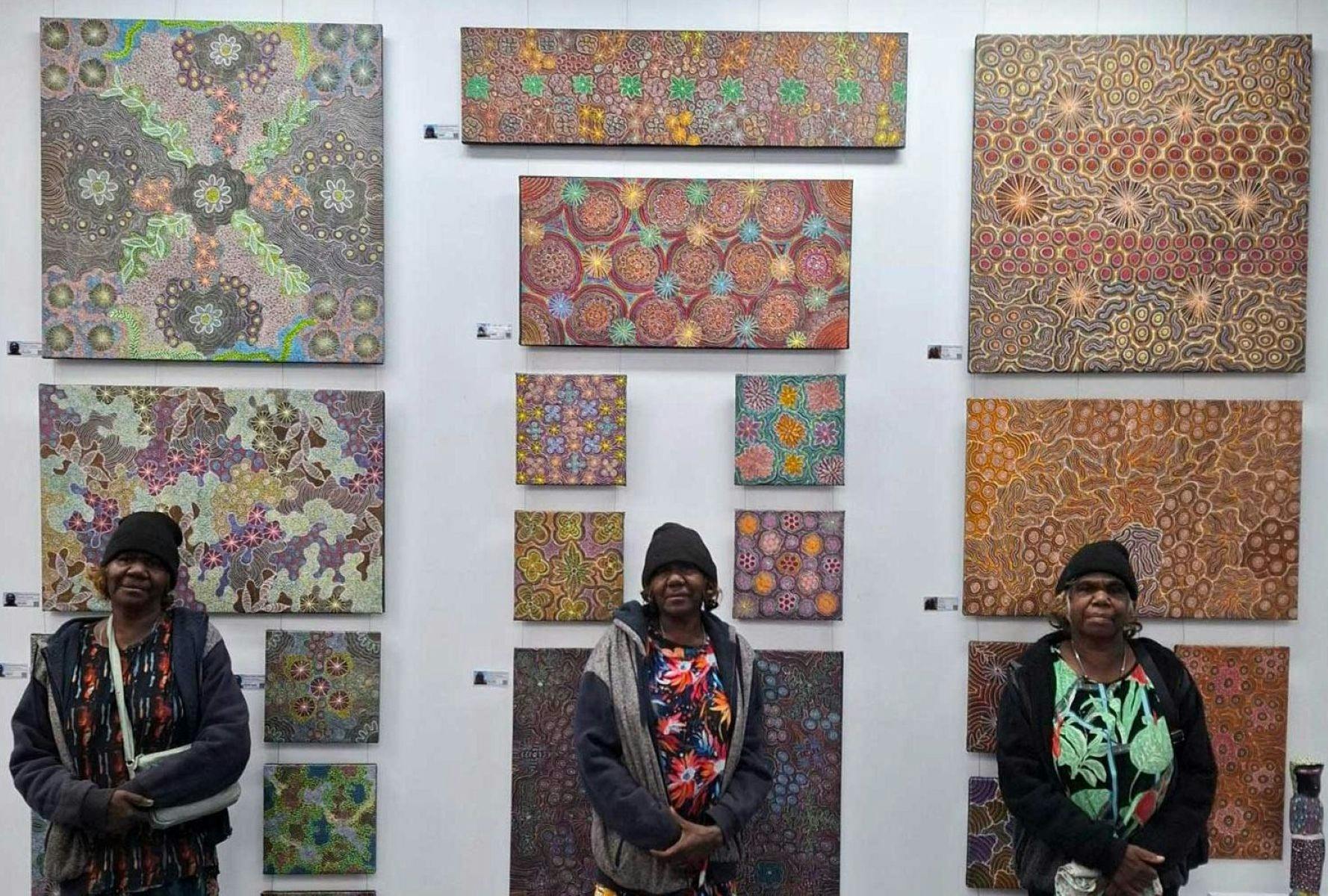 Hunter sisters standing in front of their feature wall