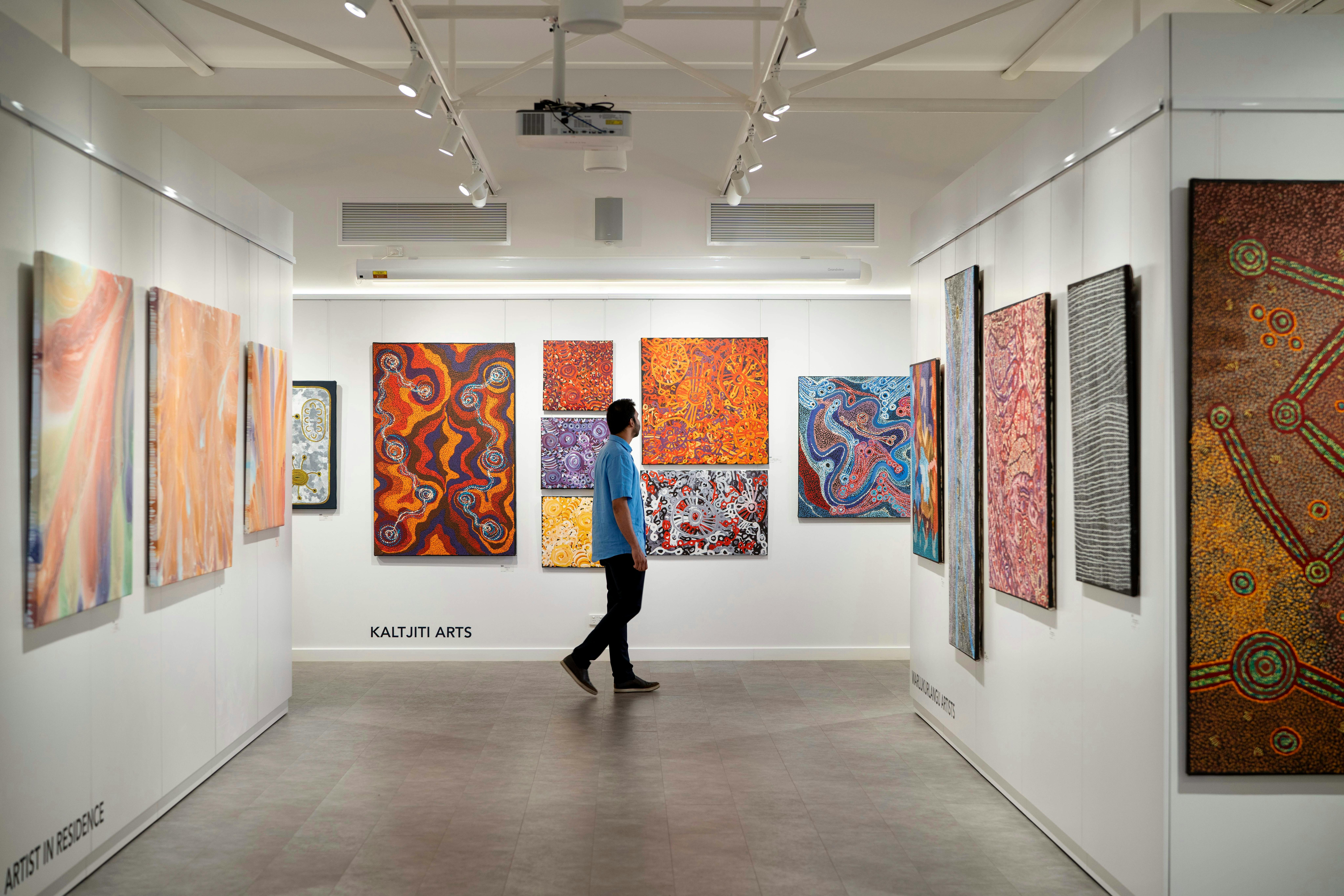 Man Walking in Art Gallery