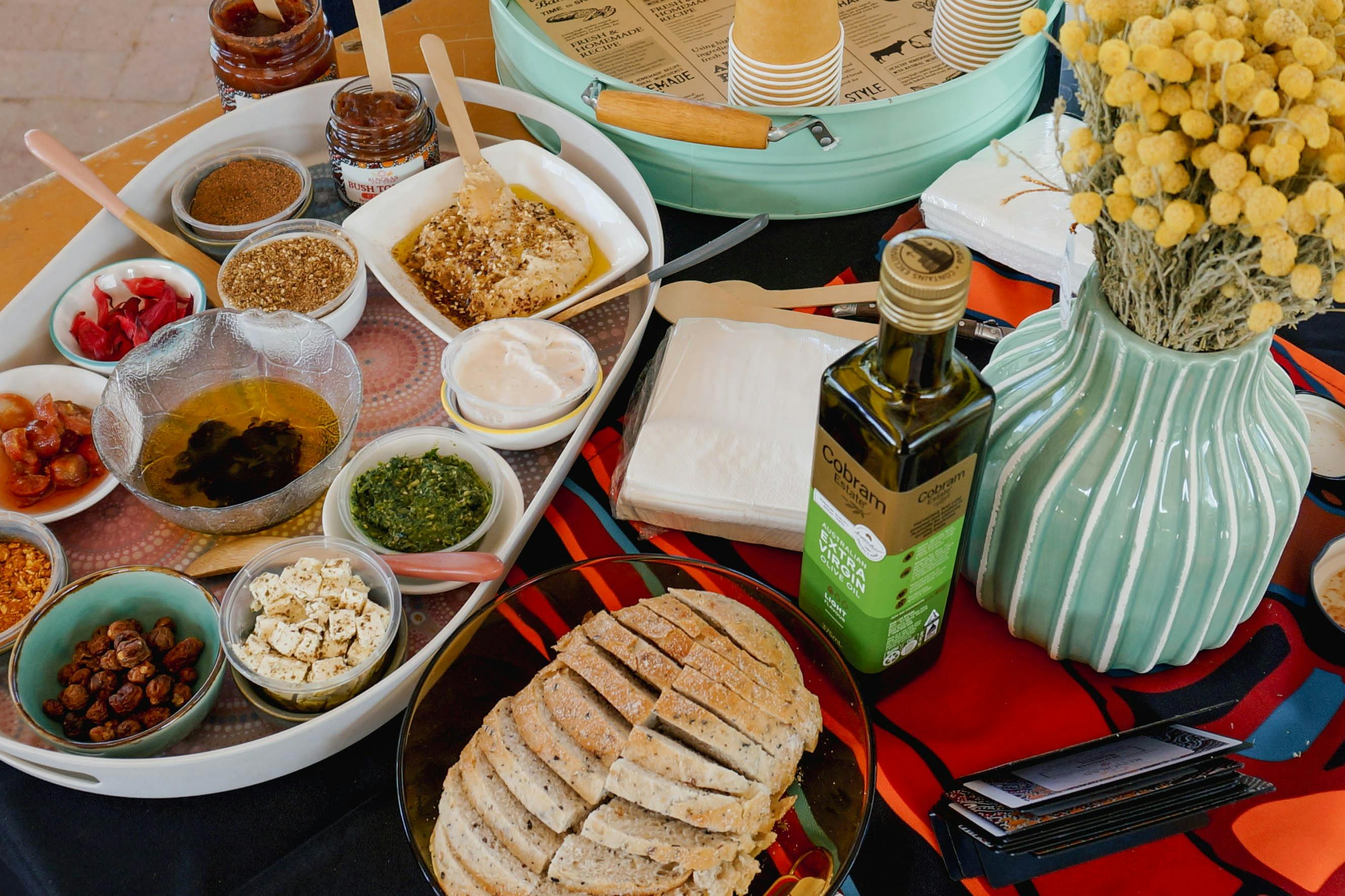 A Kungkas Can Cook bushfood tasting platter with damper, dips, spices and seeds
