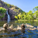 Three visitors enjoying Wangi Falls, Litchfield National Park
