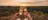 photo of champagne glasses clinking at sunset