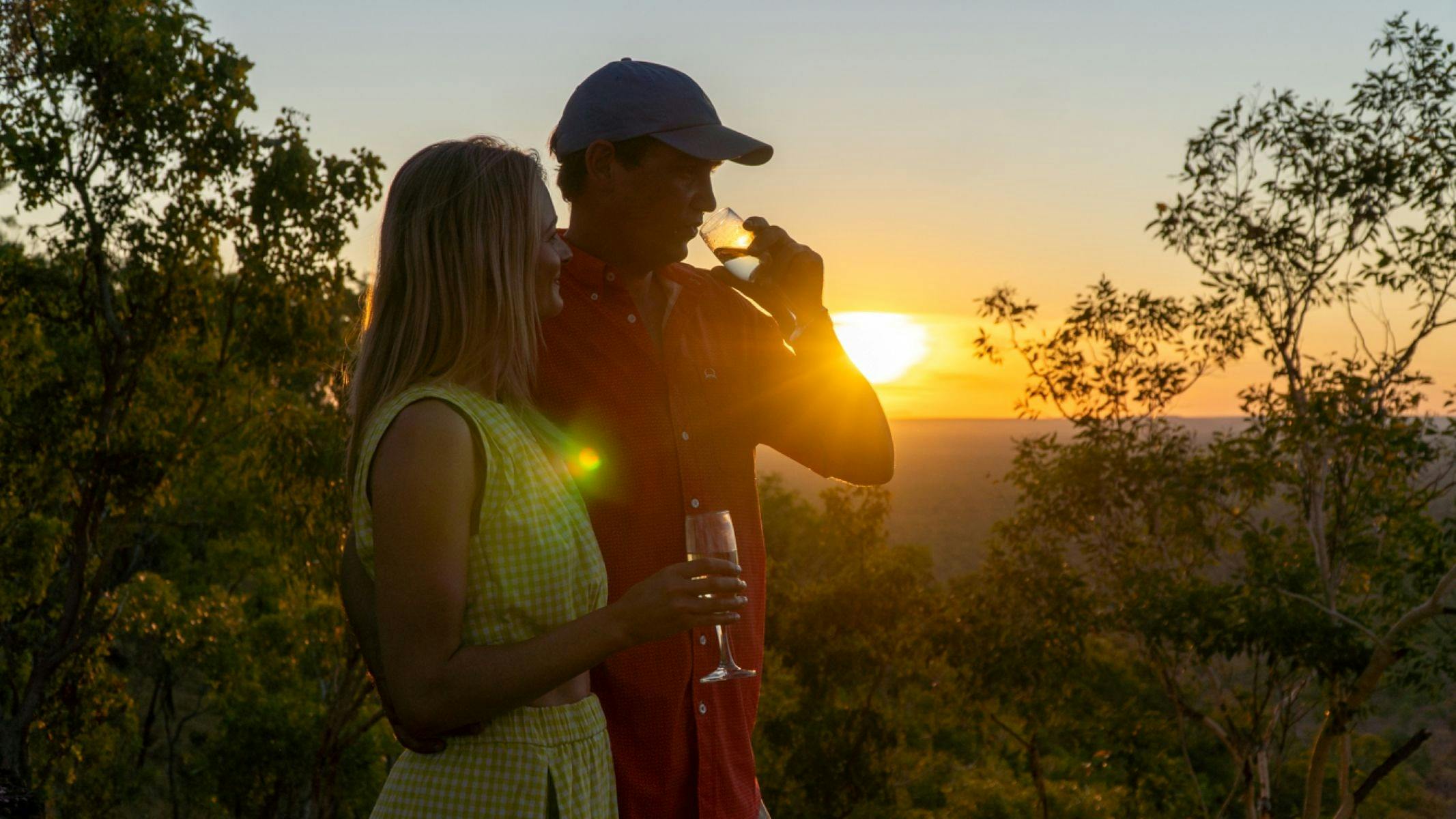 Couple with drinks at sunset
