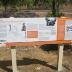 Freestanding interpretive sign at the Pioneer Cemetery detailing Adelaide River's shared heritage.