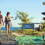 Couple walking together back to the Banu Banu Resort from the beach in East Arnhem Land