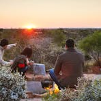 When sunrise comes watch the distant domes of Kata Tjuta come into view.