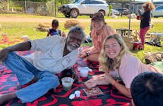 an aboriginal man poses with tourist at Barunga Festival