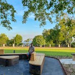 Larrakia/Mayalli artist Keelan Fejo on the bench seating at Liberty Square that features his artwork