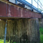 Bridge concrete pylons, steel beams and timber sleepers.