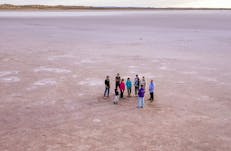 A small group explores the surface of the Salt Lake before sunset