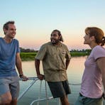Visitors with a Aboriginal guide aboard a Yellow Water Billabong cruise.