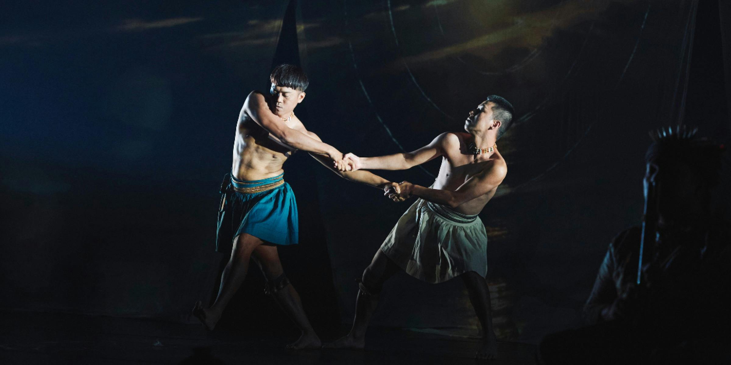 Two male characters in costume, dancing