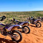 Bikes parked on top of a big sand dune