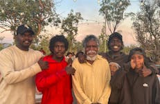 a group of Aboriginal people smile for the camera