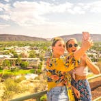 Two girls taking a selfie at Anzac Hill in Alice Springs