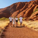 A group of friends walking around Uluru