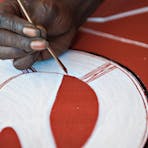 Injalak artist using traditional (rarrk) methods on a canvas