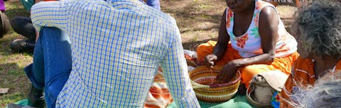 Christine Nabobbob gives visitors a demonstration of Kunwinjku weaving styles