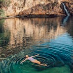 Woman floating in the water relaxing at Barramundi gorge (Maguk) in Kakadu National Park