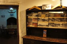 General view of interior of old homestead building, furnished in period pieces, and displays of hand-made interpretive  material.
