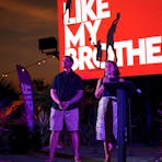 Two Larrakia people on stage performing a Welcome to Country and a Smoking Ceremony