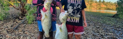 Two pople holding a barramundi at Seven Emu Station