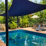 Swimming pool and seating area at the Lazy Lizard Caravan Park.