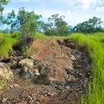Access road to the explosive magazines is in poor condition and washed away.  The road leads to a small creek crossing and low lying areas that are wet.