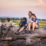 isitors looking over the Kakadu landscape with an Aboriginal guide.