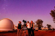 Woman looking through telescope