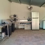 Communal kitchen with two barbeques with gas stoves, fridge, sink, microwave, kettle, pots & pans and utensils. A free washing machine is available.