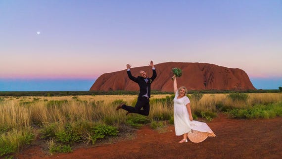 Wedding photoshoot of Alicia and Wade posing in front of Uluru