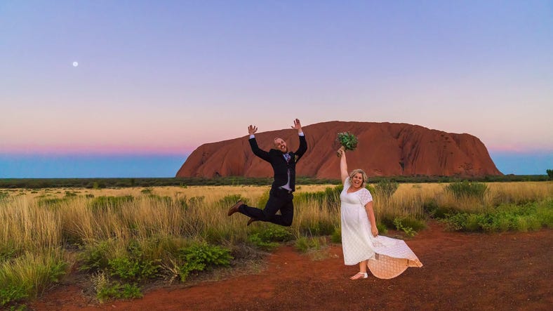 Wedding photoshoot of Alicia and Wade posing in front of Uluru