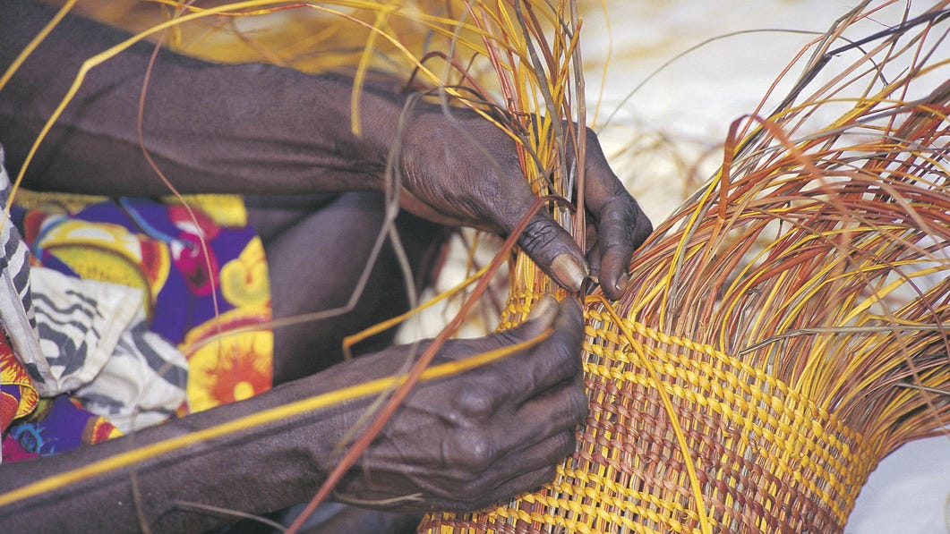 Aboriginal woman weaving near Tiwi Islands