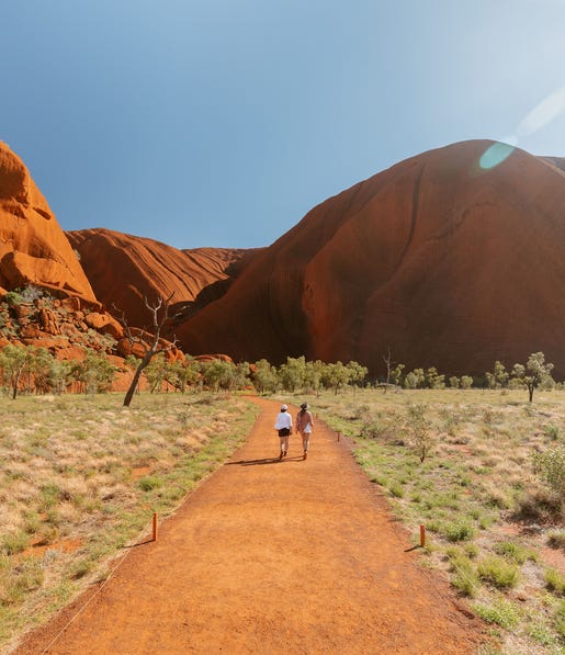 women walking around Uluru