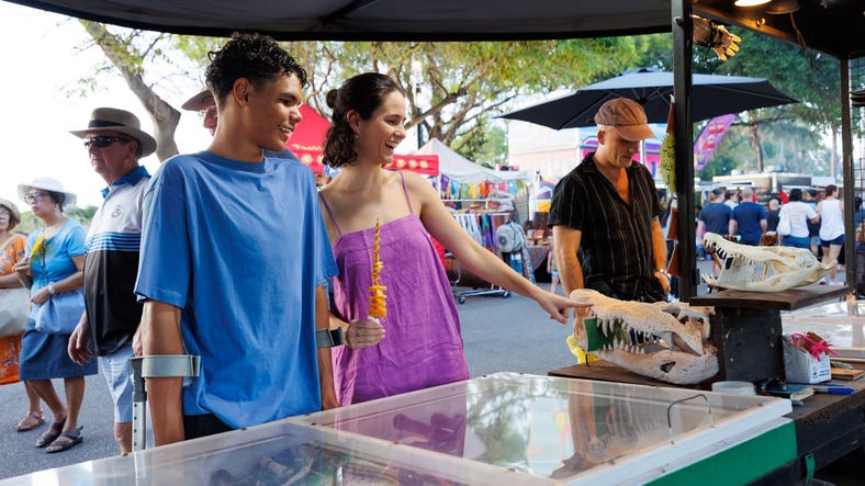 People shopping at market stall