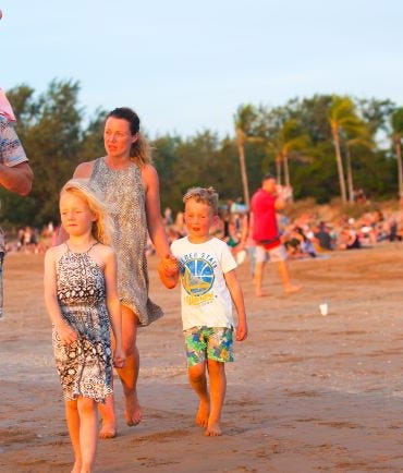Family walking along Mindil beach
