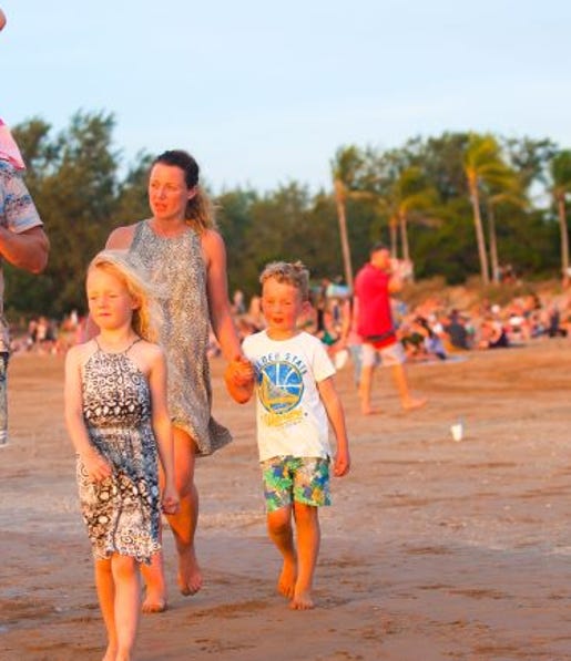 Family walking along Mindil beach