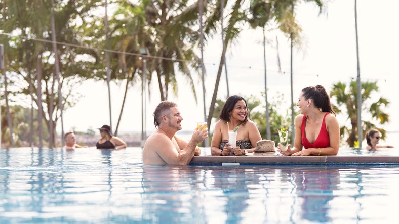 People drinking cocktails in an infinity pool in Darwin