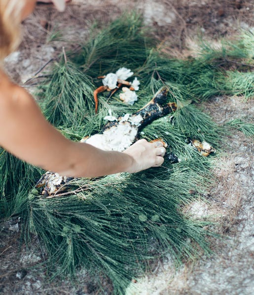 Emily Hutchinson cooking a fish on the Tiwi Islands Clearwater Island Lodge Marine Culture Tou