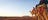 A group of people riding camels on a tour of Uluru