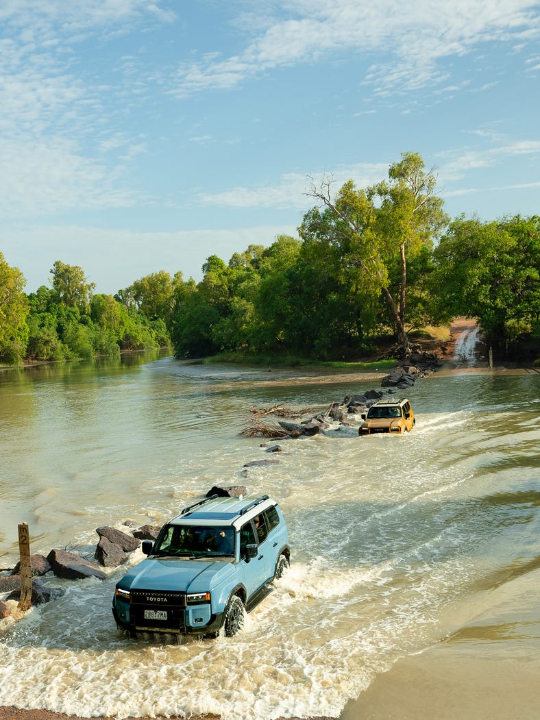 4WD vehicles drive across Cahills Crossing