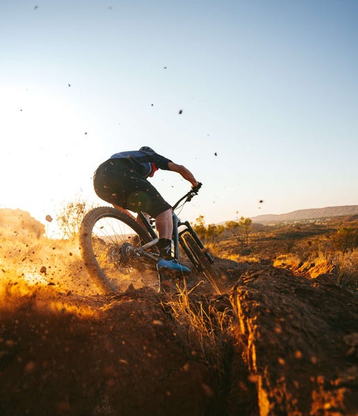 Person skidding dirt while mountain biking in Alice Springs