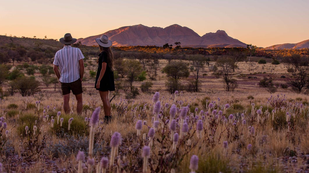 Couple looking at Mount Sonder during the sunset near Alice Springs