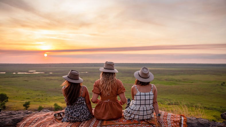 group of friends watching sunset at ubirr