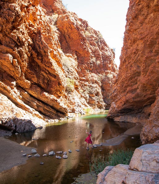 woman crossing water using stepping stones at simpsons gap