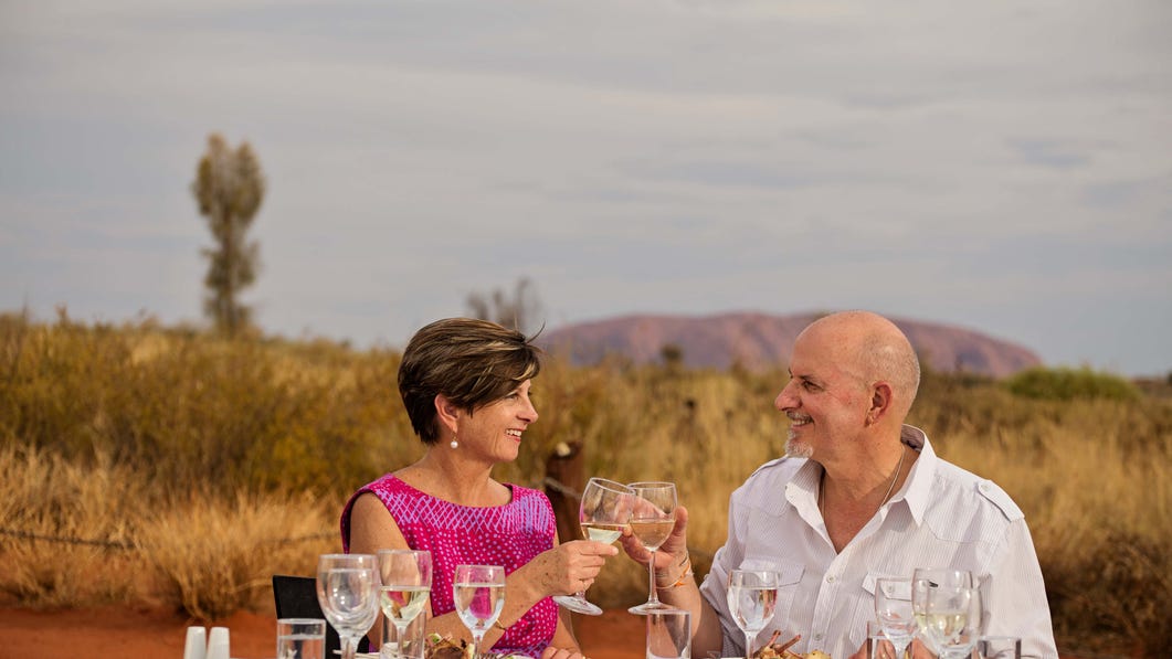 Couple toasting at Sounds of silence dinner Uluru